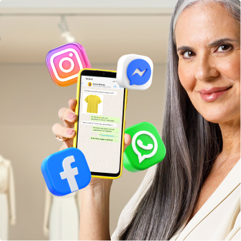 Uma pessoa segura um smartphone que exibe a imagem de uma camiseta amarela e informações de venda, enquanto ícones tridimensionais de Instagram, Messenger, WhatsApp e Facebook flutuam ao redor do aparelho.